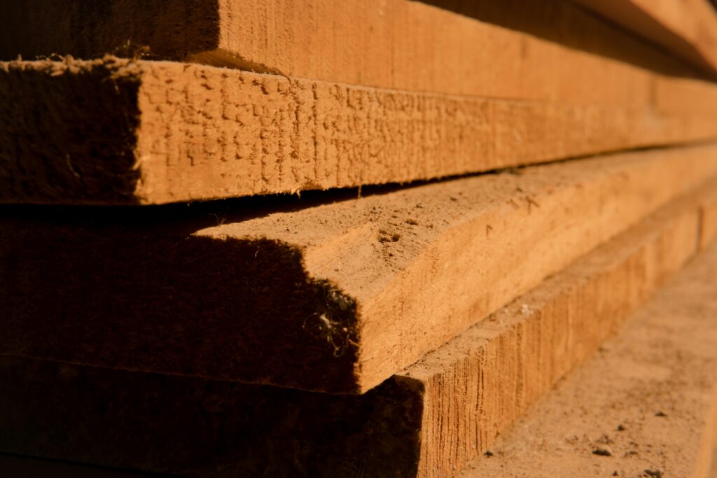pexels-photo-8447801-8447801 Detailed view of stacked wooden planks, highlighting texture and shadows in natural light.